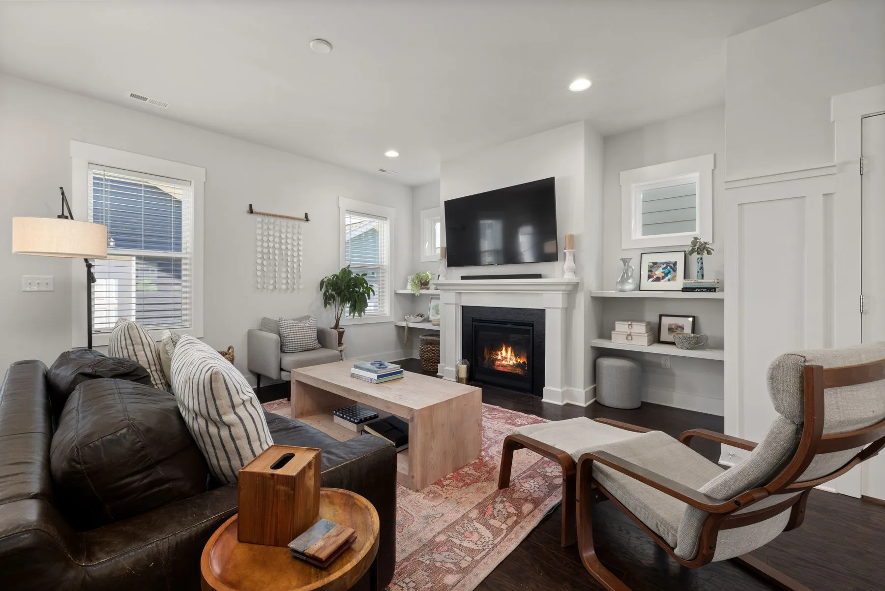 Bright, freshly cleaned living room with a fireplace in a Louisville single-family home